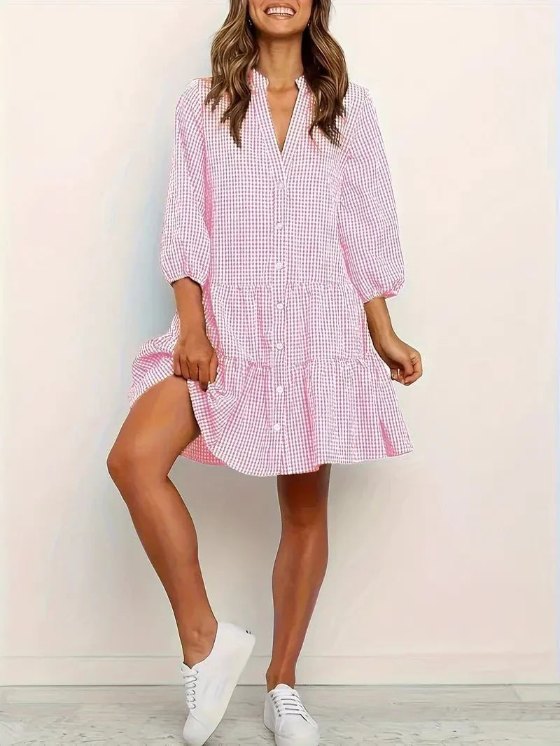 Women's pink gingham tiered mini dress with V-neck and 3/4 puff sleeves for casual summer fashion.