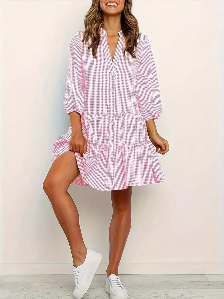 Women's pink gingham tiered mini dress with V-neck and 3/4 puff sleeves for casual summer fashion.