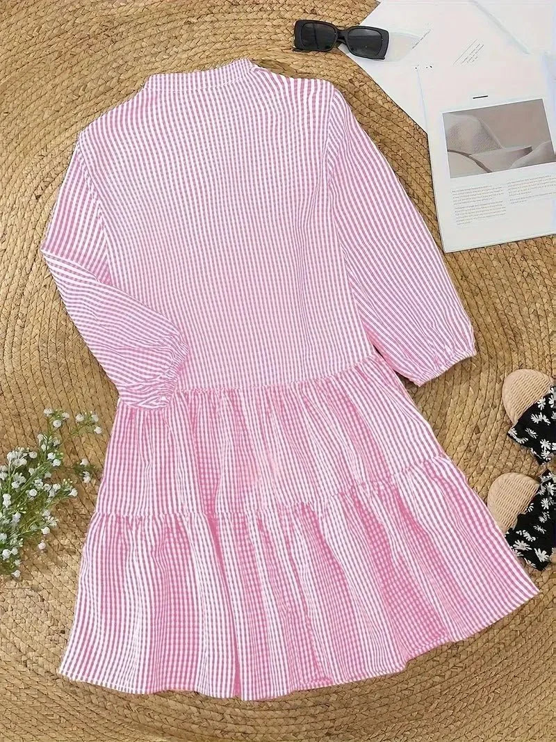 Women's flowy tiered gingham mini dress in pink, with V-neckline and 3/4 sleeves for everyday style.