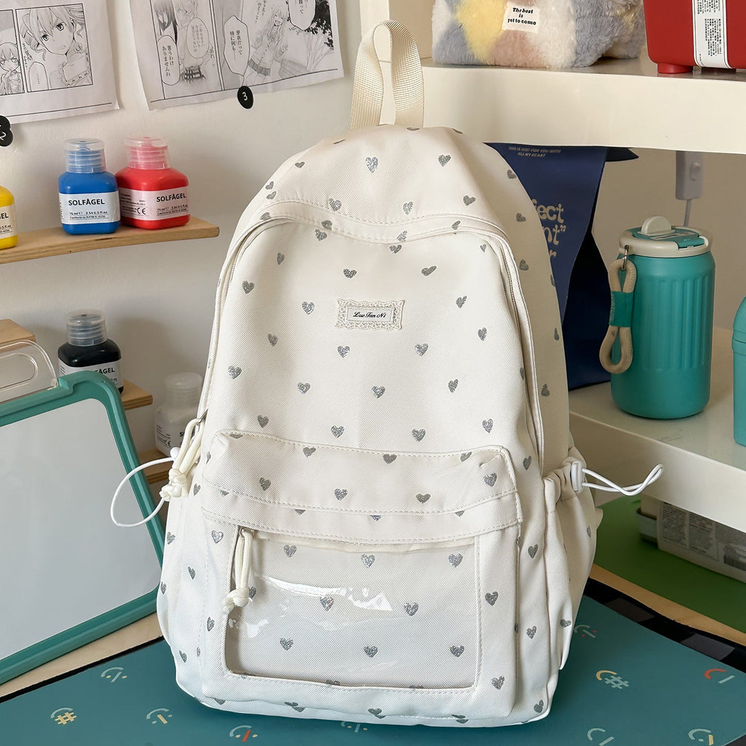 Women's pink heart-patterned school backpack, ideal for casual daily carry & college. Stylish & durable design.