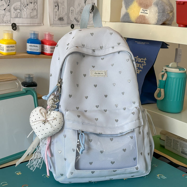 Stylish women's pink heart-patterned casual backpack, perfect for school, daily carry, or light travel. Cute & durable.