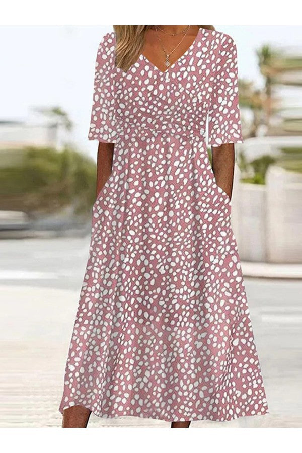 Women's pink polka dot midi dress with v-neck. Flowy, tummy-flattering, elegant, perfect for summer occasions.