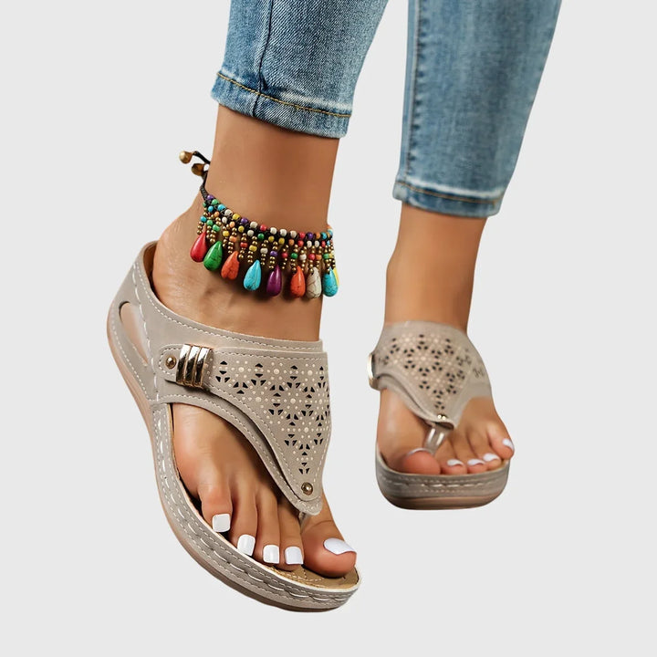 Women's heeled platform slip-on sandals with a distinctive cut-out thong strap. Trendy summer footwear.
