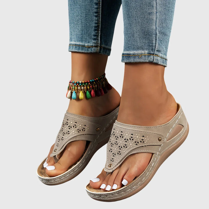 Stylish women's platform sandals featuring unique cut-out thong strap design. Slip-on for comfort.