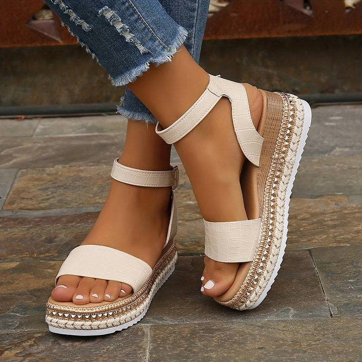 Black women's platform sandals with a comfortable ankle strap. Perfect open-toe summer footwear for stylish outfits.