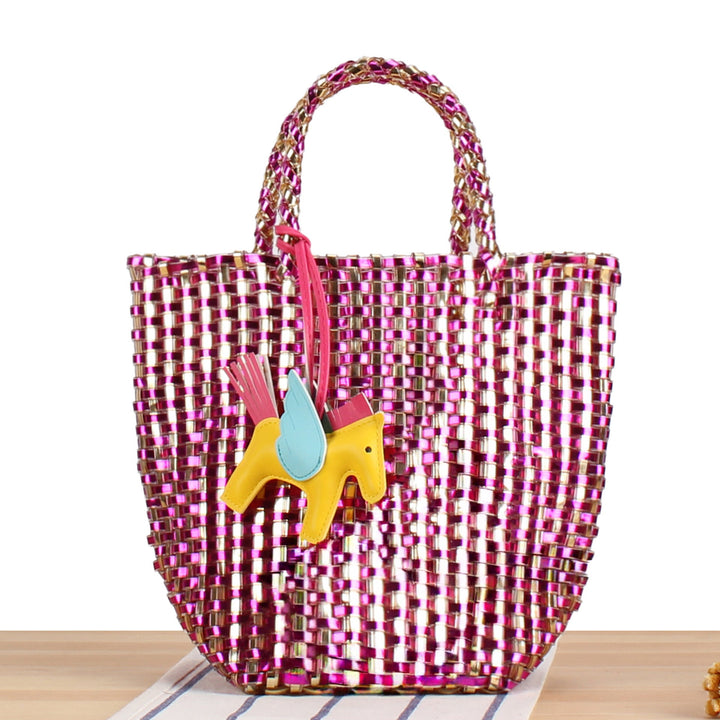 Unique charm detail on a women's playful handwoven basket tote bag, perfect for summer style.