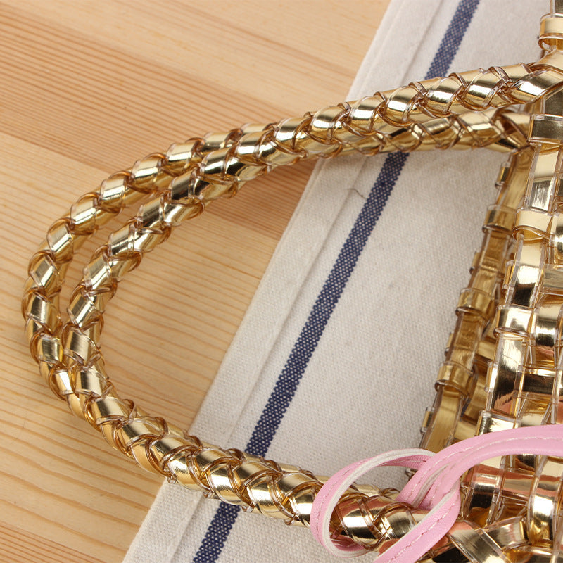 Handwoven straw basket bag for women, a stylish summer tote with playful charm.