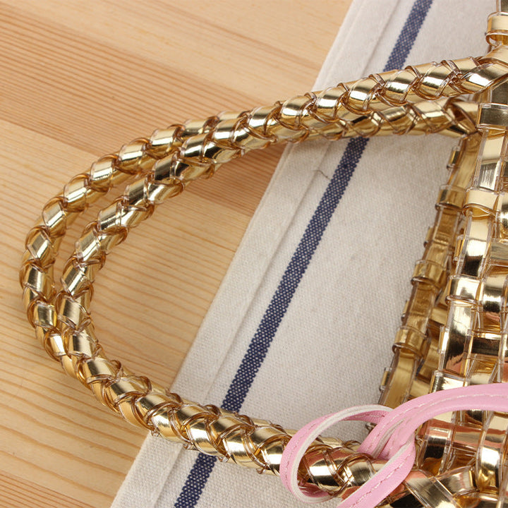 Handwoven straw basket bag for women, a stylish summer tote with playful charm.