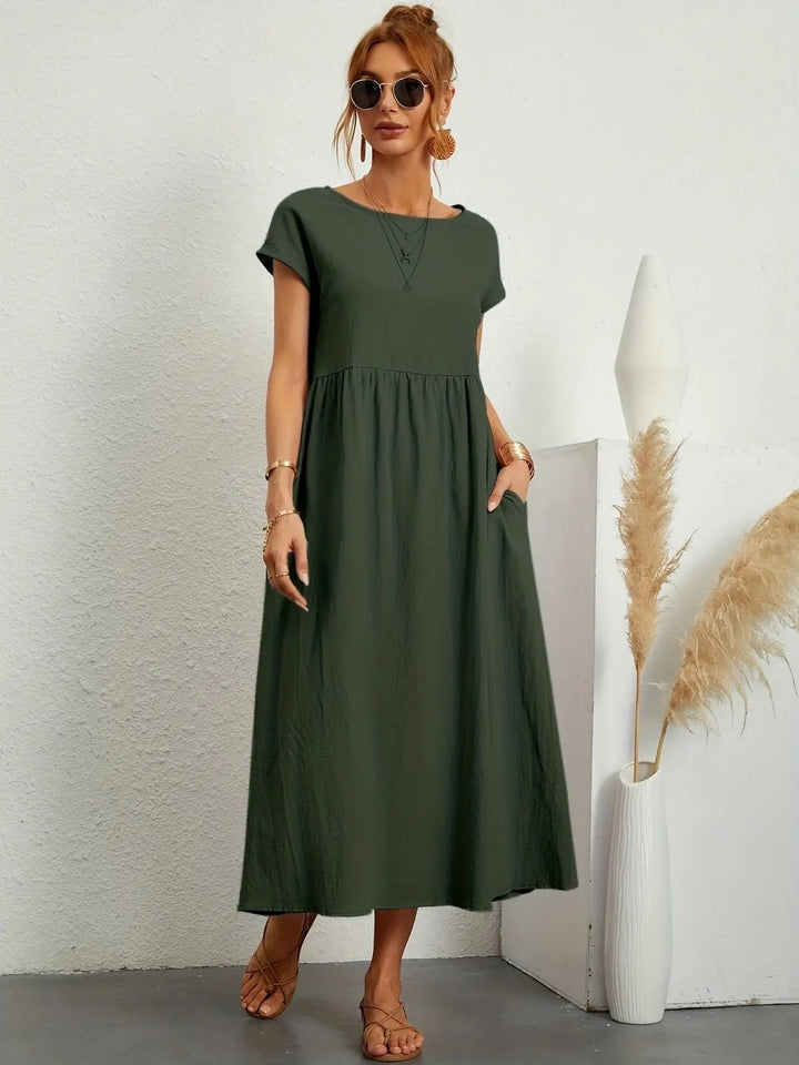 Women's pleated empire waist midi dress with round neck & short sleeves, perfect for casual or day wear.