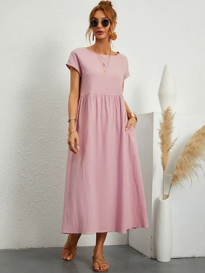 Flowy women's pleated midi dress with an empire waist, round neck, and short sleeves, ideal for any occasion.