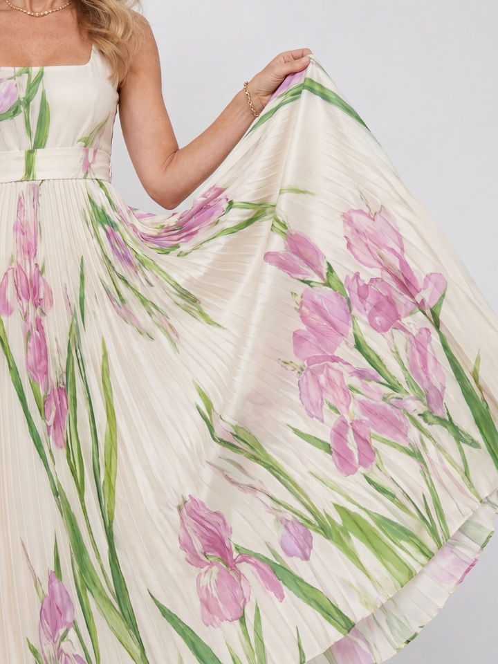 Elegant women's sleeveless midi dress with vibrant floral print and flowy pleated design.