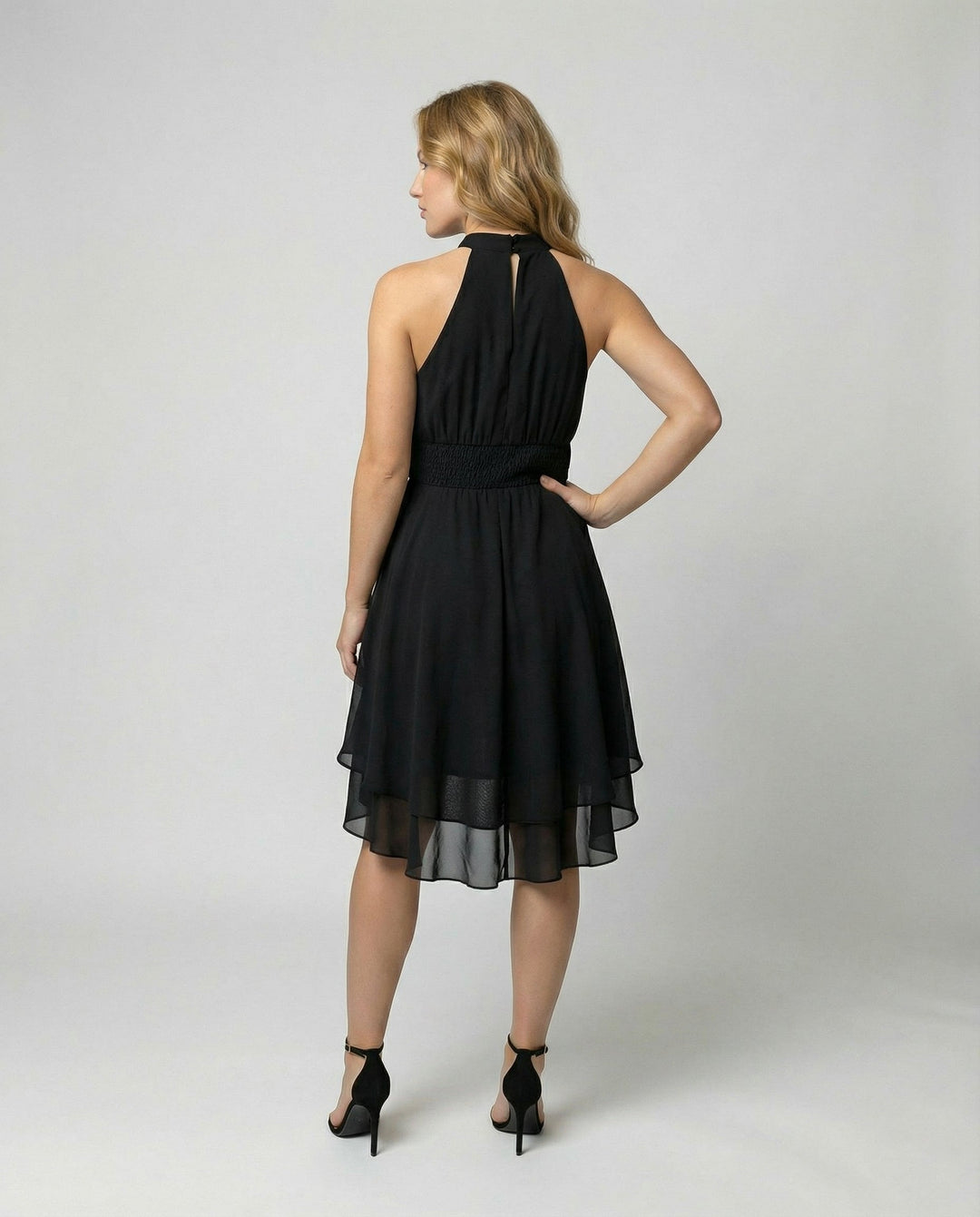Elegant pleated mini cocktail dress for women, featuring a stylish halter neckline.