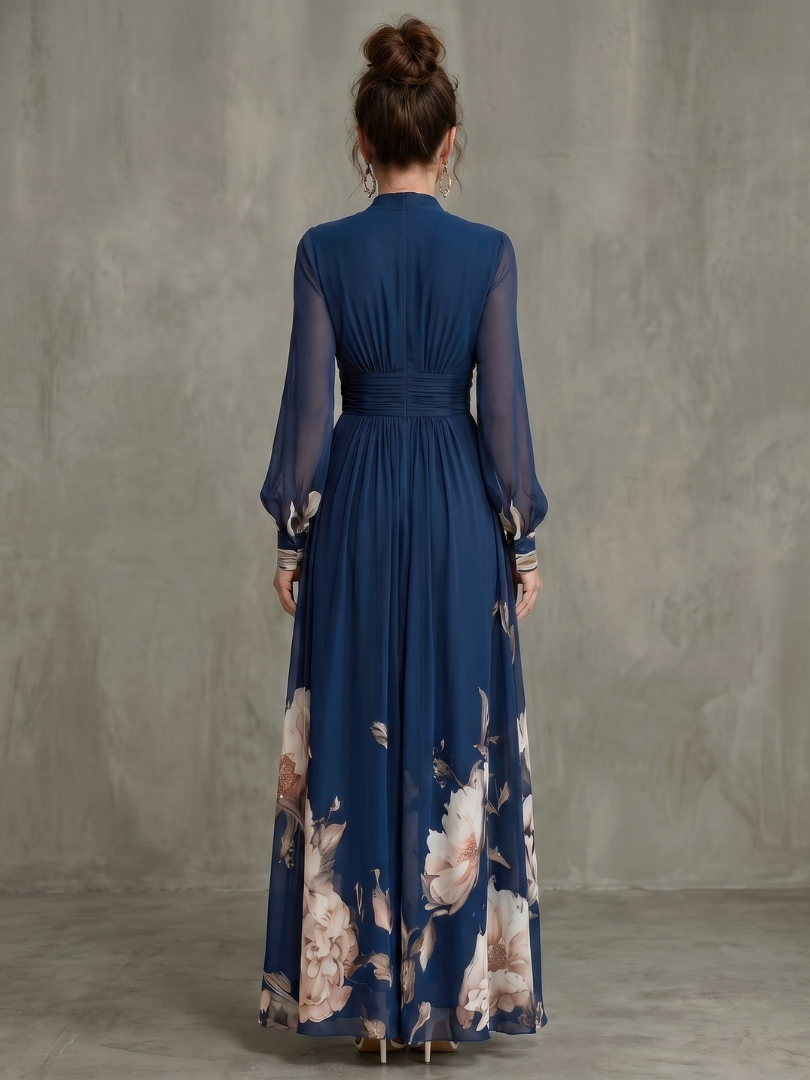 Chic women's pleated floral maxi occasion dress with sheer sleeves. Perfect elegant choice for a wedding guest.