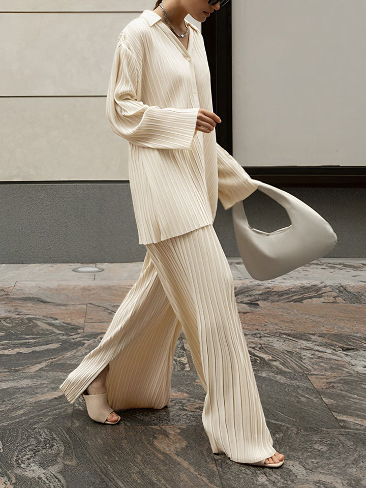 Women's pleated two-piece set with relaxed fit top and wide leg pants, perfect for elegant or casual style.