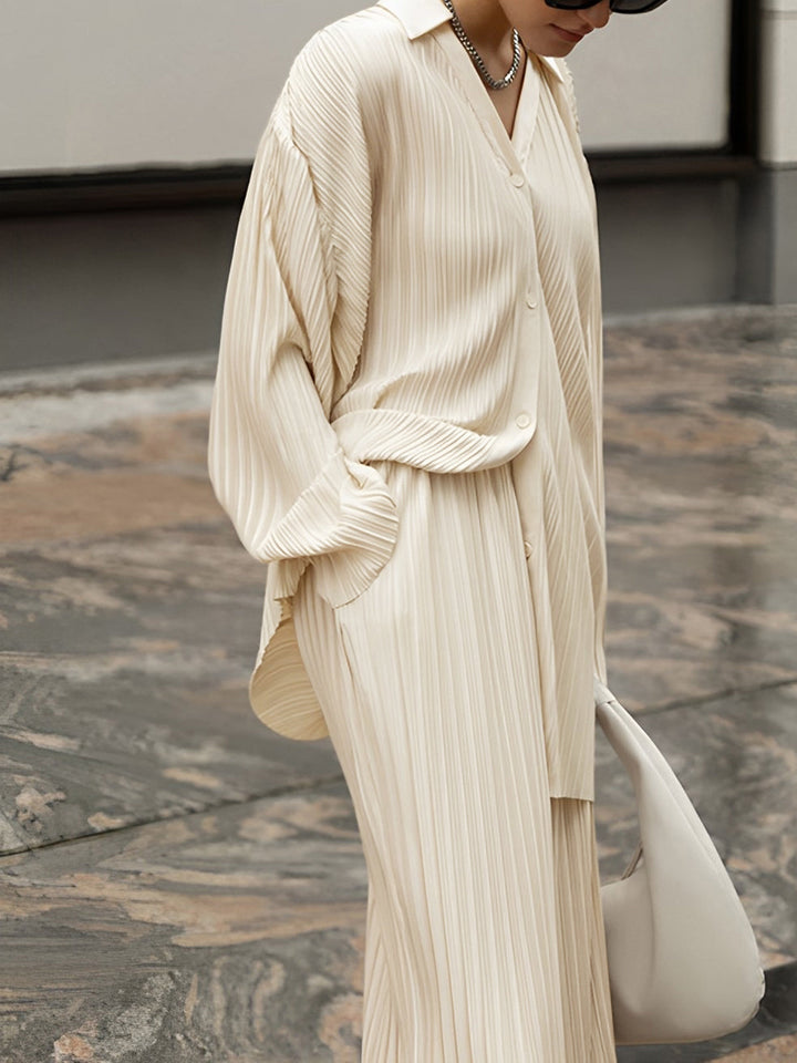 Chic women's pleated co-ord set. Relaxed fit top & wide leg pants offer modern comfort and versatile style.