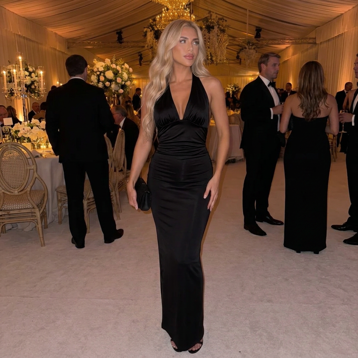 Fitted ruched maxi dress featuring a chic plunge halter neckline. Ideal as a formal evening gown or party dress.