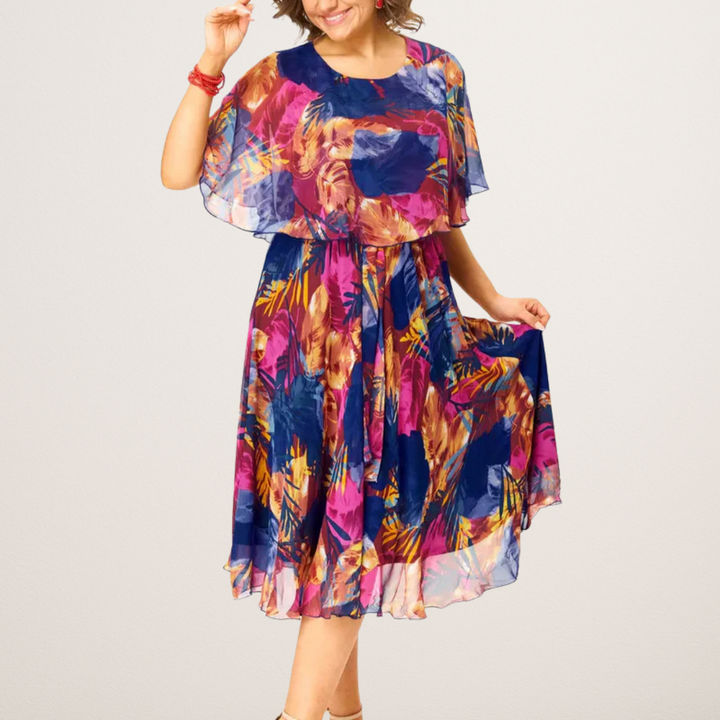 Women's plus size flowy summer midi dress with vibrant print, perfect for casual wear or vacation comfort.