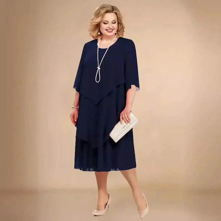 Stylish women's plus size formal midi dress, layered and asymmetrical, suitable for wedding guests or cocktail parties.