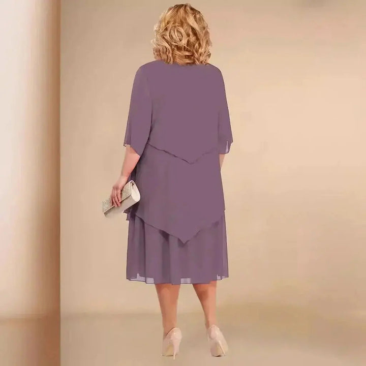 Chic women's plus size evening dress featuring a unique layered asymmetrical midi length. Perfect for formal events.