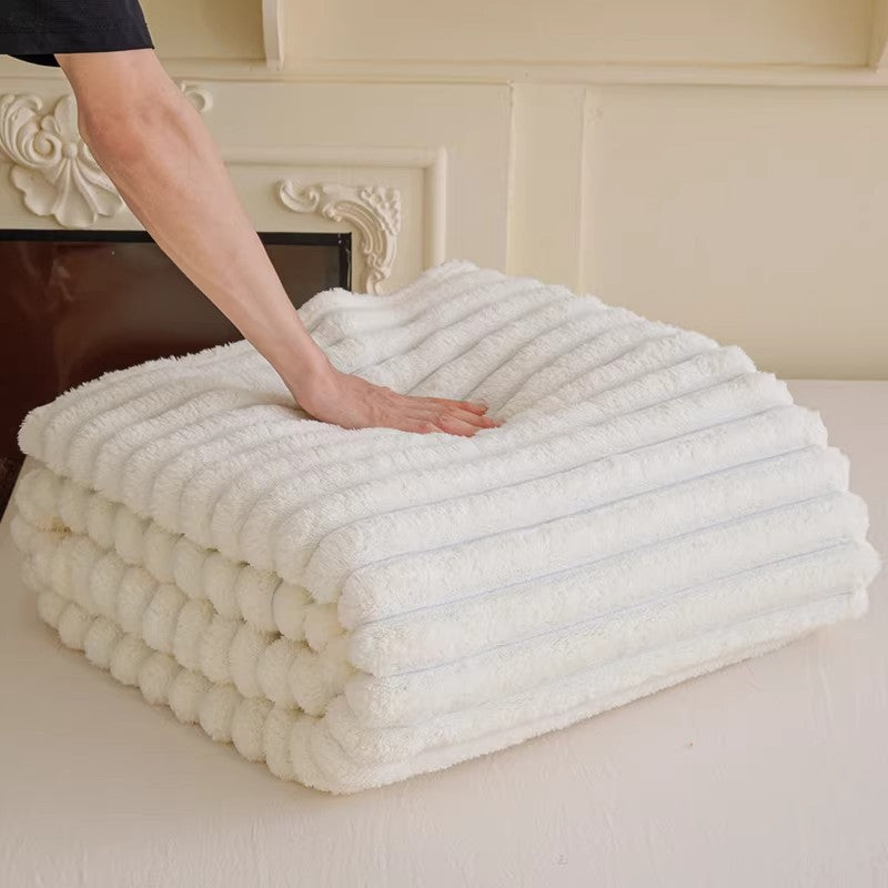 Softest women's snuggle blanket, a warm plush throw with elegant 3D texture for cozy evenings.