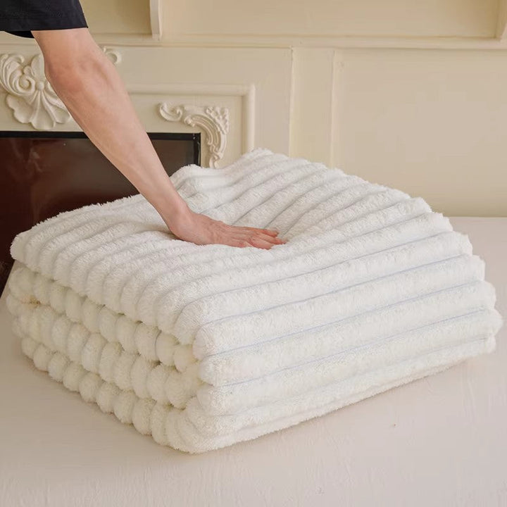 Softest women's snuggle blanket, a warm plush throw with elegant 3D texture for cozy evenings.