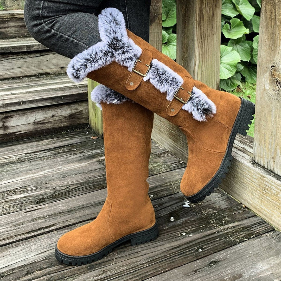 Durable women's snow boots, knee-high & plush-lined, designed for comfort in winter conditions.