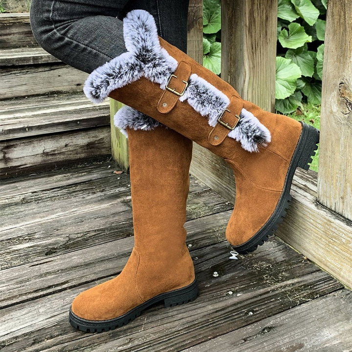 Durable women's snow boots, knee-high & plush-lined, designed for comfort in winter conditions.