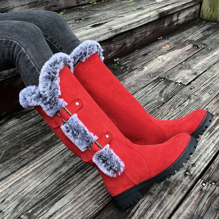 Elegant women's tall winter boots with decorative buckles and a soft, plush interior lining.