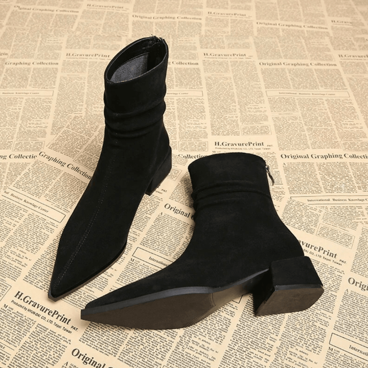 Comfortable women's pointed toe ankle boots, designed with a chic block heel for elegant footwear.