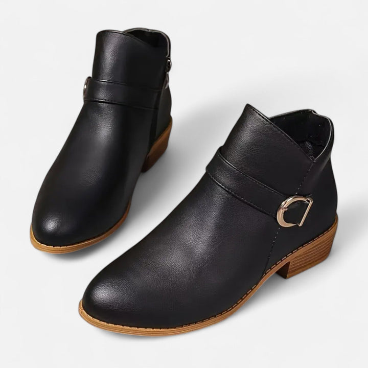 Women's pointed-toe ankle boots with chic buckle detail. Elegant footwear for versatile fashion.
