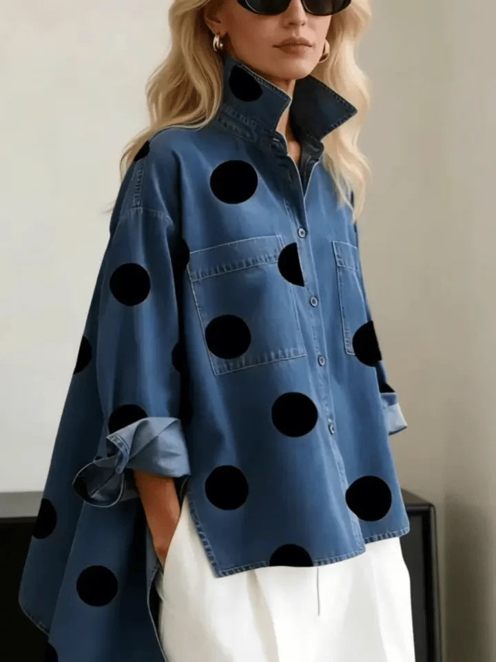 Stylish women's oversized polka dot shirt, featuring a button front and trendy high-low hem. Versatile blouse.