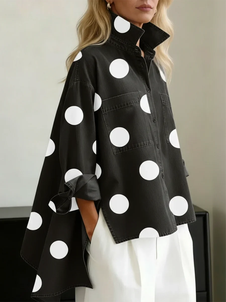 Front view of women's oversized polka dot blouse with button closure. High-low hem, perfect for stylish casual looks.