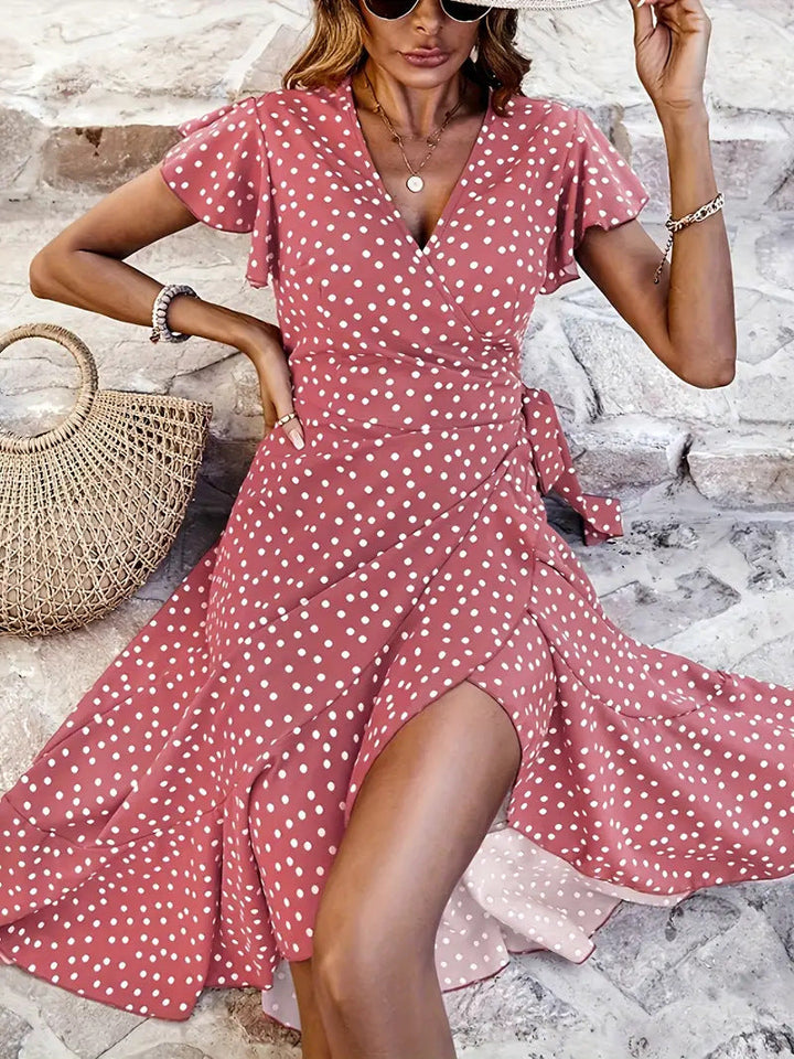 Playful polka dot women's wrap dress, midi length with a chic, flowy skirt detail and adjustable comfortable fit.