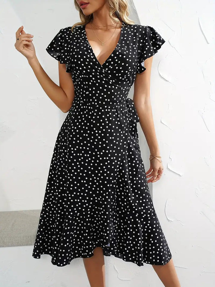 Chic women's polka dot wrap midi dress, elegant with a flowy playful skirt, perfect for summer vacation wear.
