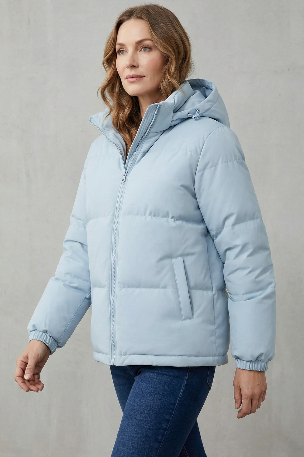 Warm women's hooded puffer jacket, quilted for winter comfort. Ideal lightweight casual outerwear.