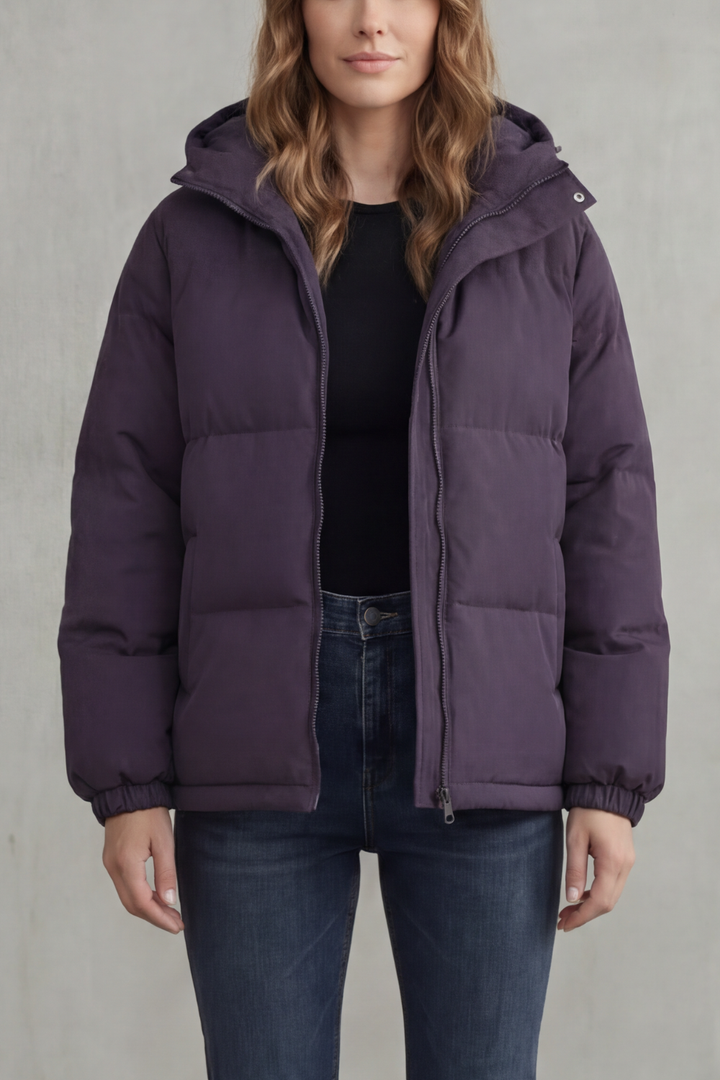 Premium women's quilted puffer jacket with hood. Durable, warm, & stylish for cold weather.