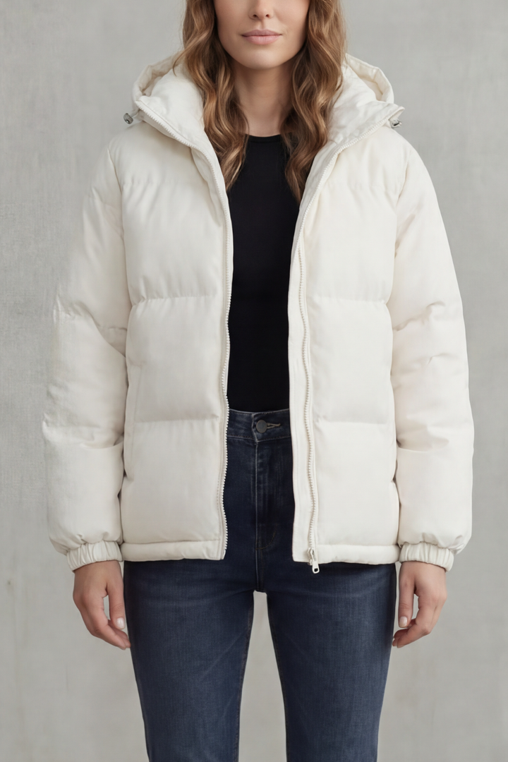 Modern women's hooded quilted puffer jacket. Lightweight, warm, and stylish for casual winter outfits.