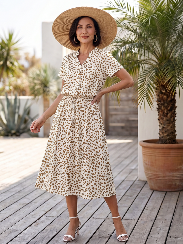 Relaxed fit women's printed midi dress. Short sleeve, button front, belted, versatile summer style.
