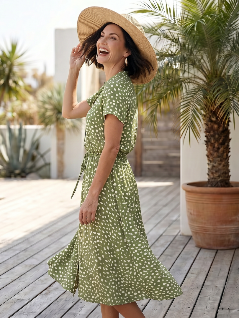 Green printed button front midi dress with belt. Short sleeve, relaxed fit for women.