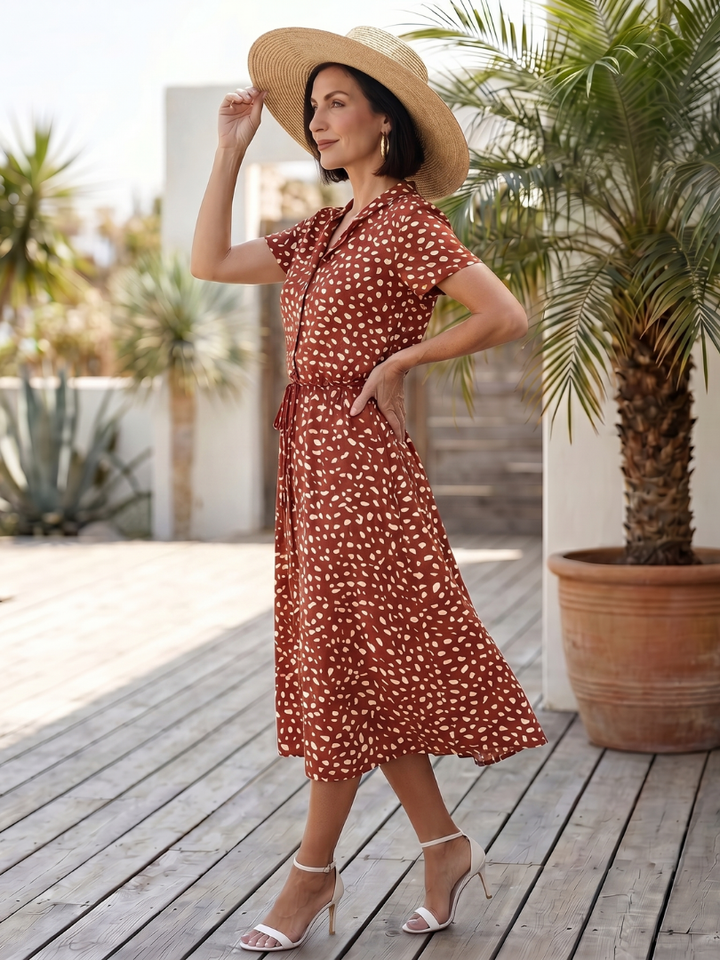 Versatile printed midi dress with vibrant pattern. Short sleeve, button front, belted, women's casual.