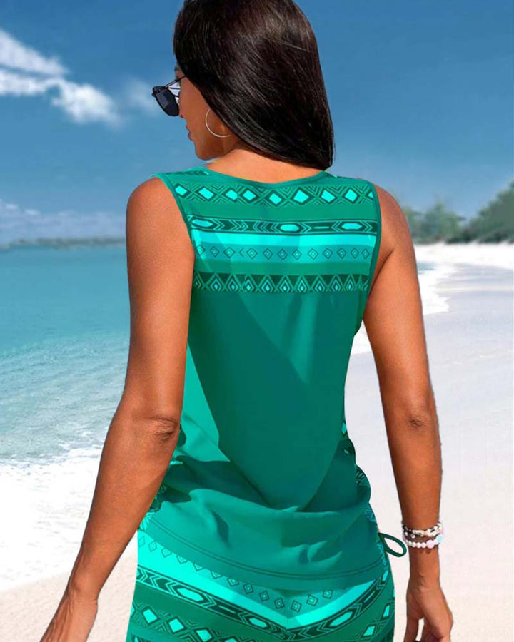 Two-piece women's tankini swimsuit featuring a vibrant print & chic criss cross neck.