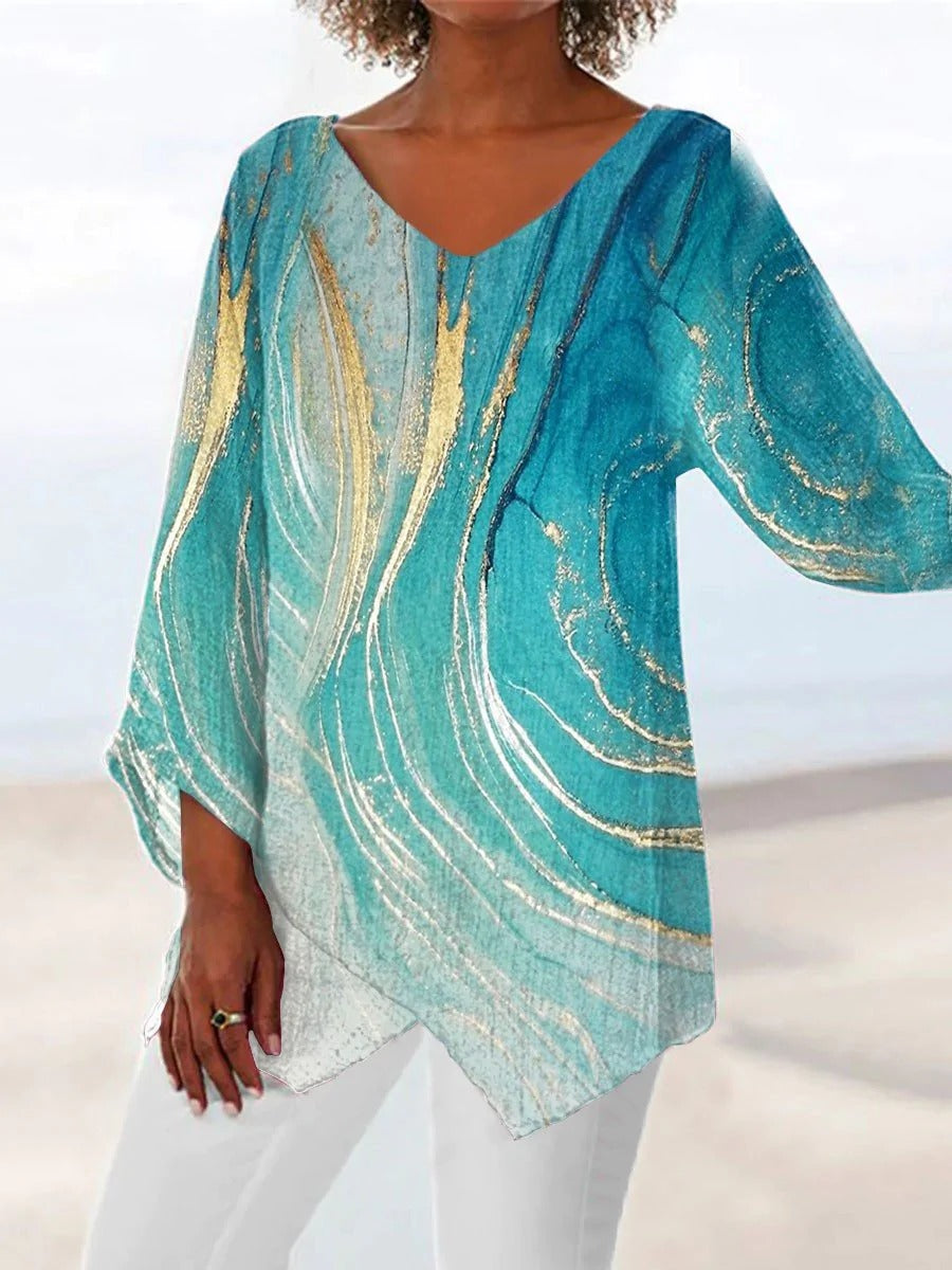 Women's printed flared asymmetrical draped long sleeve top. Stylish casual blouse for versatile wear.
