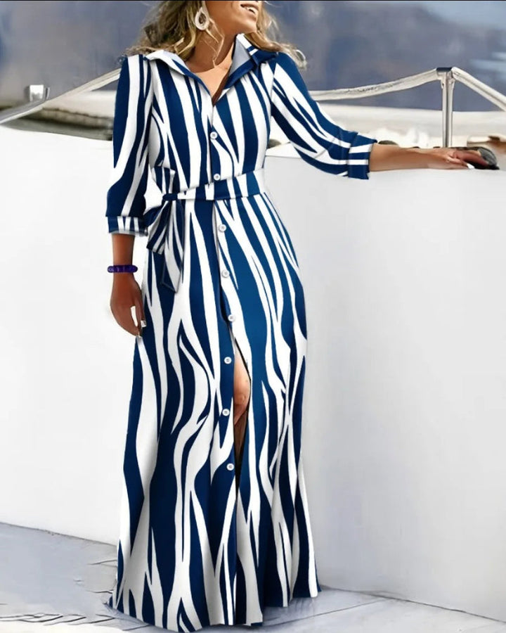 Chic women's belted long sleeve printed midi dress, styled as a versatile shirt dress for fall fashion.