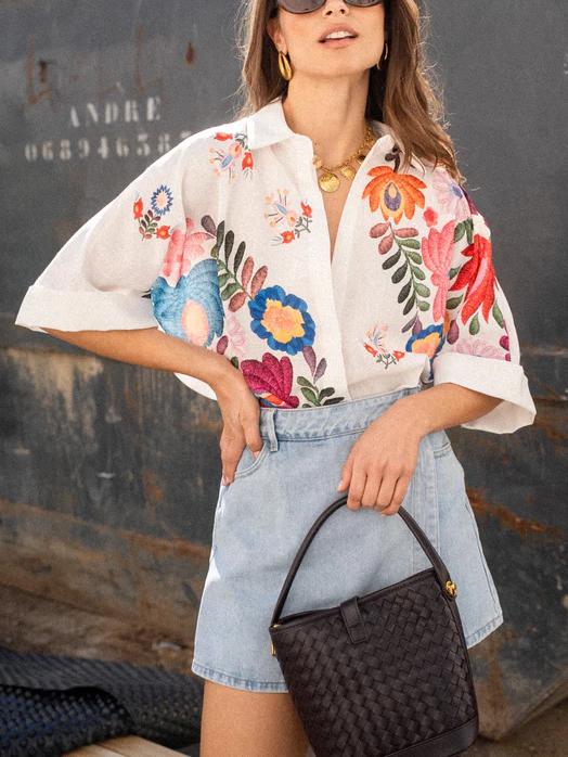 Stylish women's printed button-front blouse, a versatile short-sleeve top for casual everyday summer outfits.