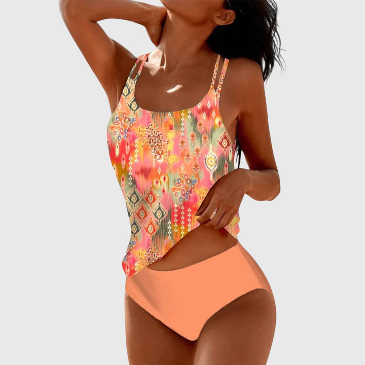 Vibrant printed women's tankini swimsuit featuring a chic strappy top. Flattering two-piece beachwear for women.