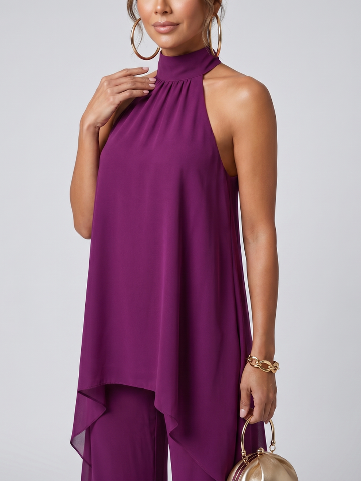 Elegant women's purple two-piece set featuring an asymmetric tunic with halter neck and comfortable wide leg pants.
