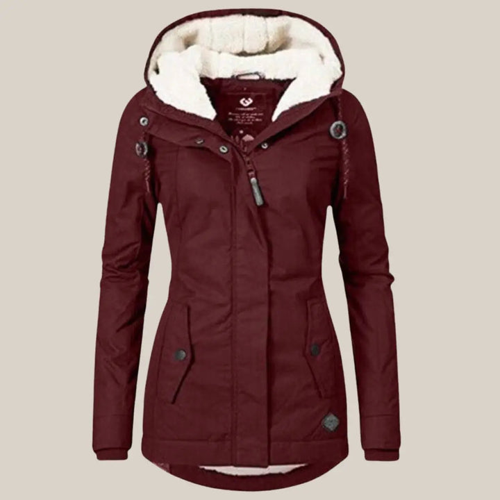 Protective women's hooded quilted outerwear, fleece-lined for superior winter warmth.
