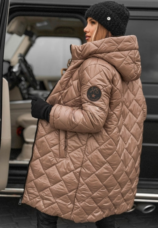 Side profile of a women's quilted jacket with hood, diamond panel design, offering warmth & style.