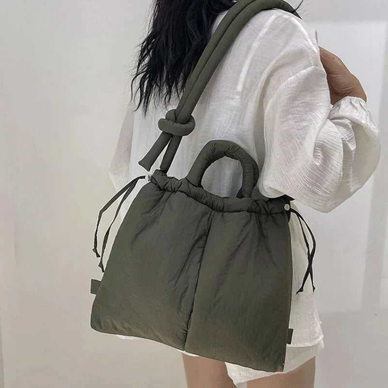 Women's quilted puffer tote bag with drawstring sides & knot-detail shoulder strap. Stylish everyday bag.