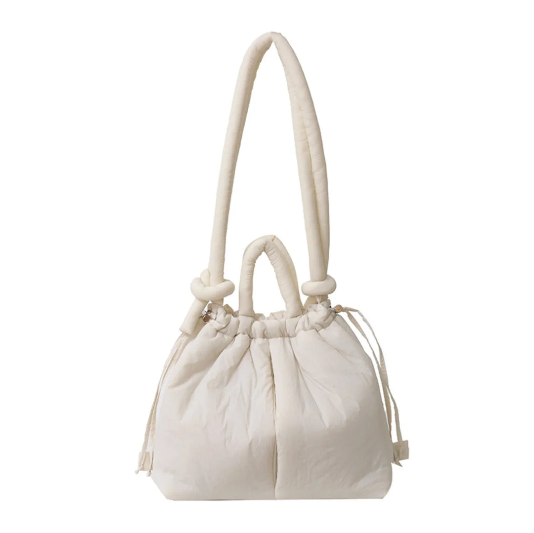 Chic quilted puffer bag for women, a stylish shoulder tote with convenient drawstring sides & knot strap.